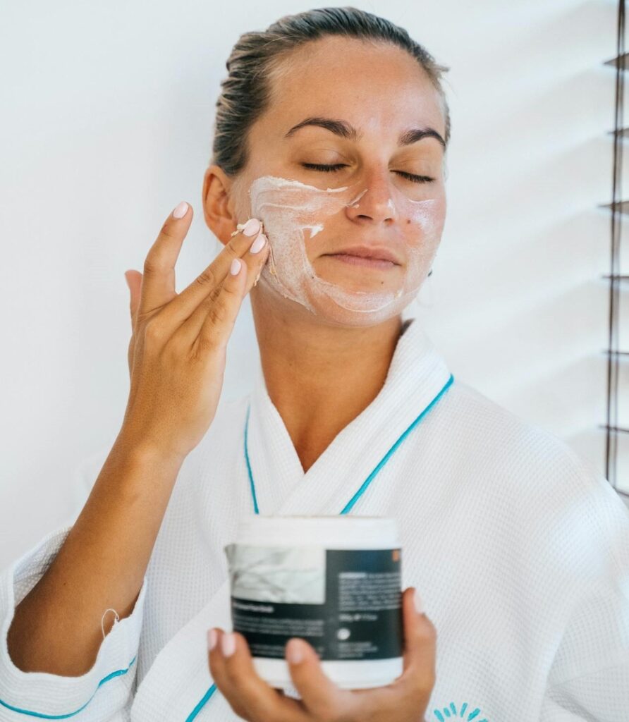 women applying facial cleanser to the face