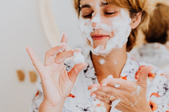 women holding facial cleanser