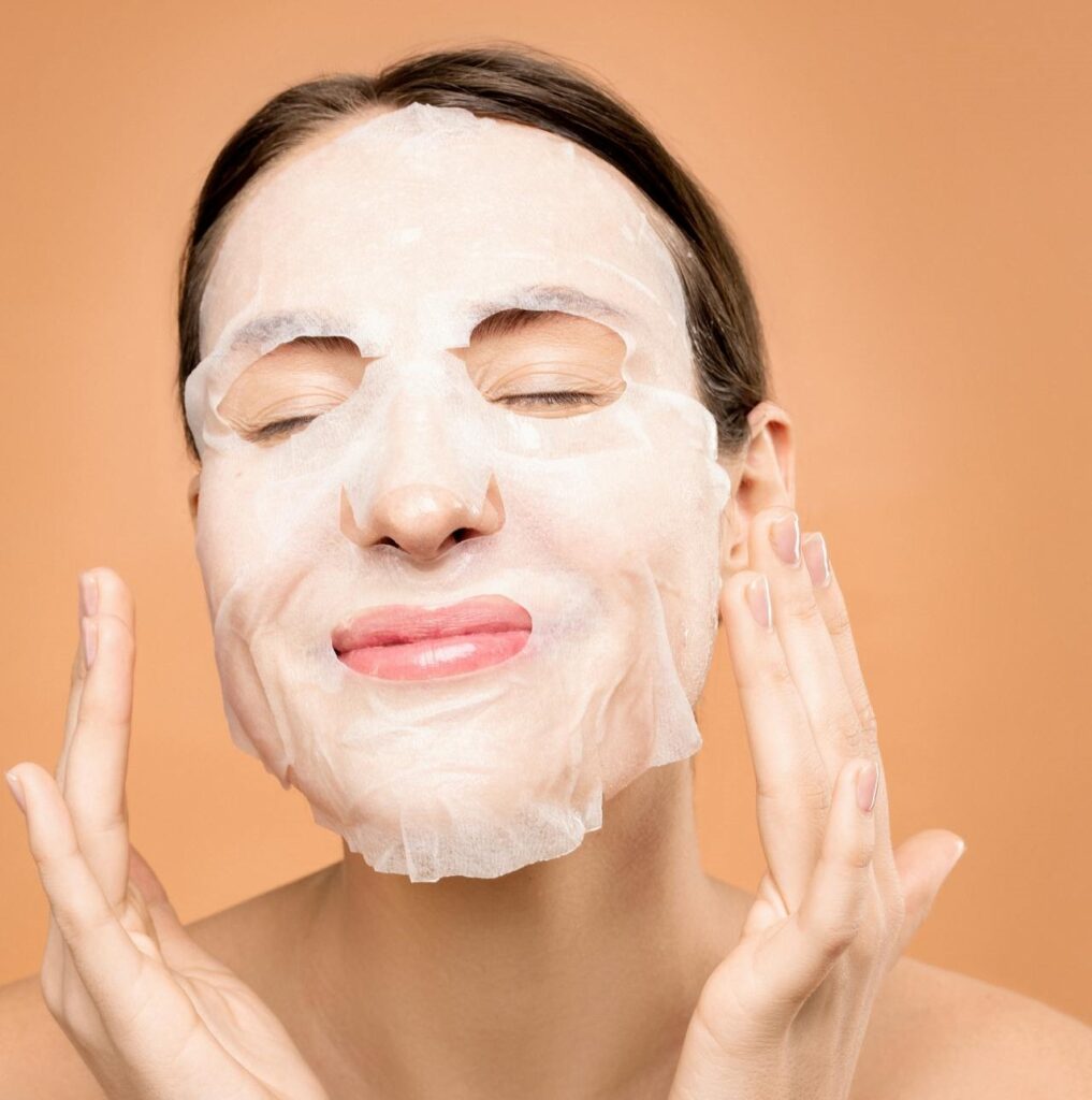 Woman cleansing her face, the essential first step in the correct order for skincare to remove impurities.