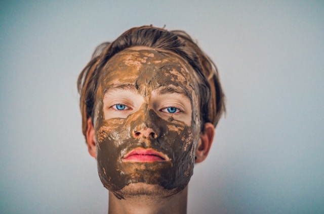 Women applying gray clay mask